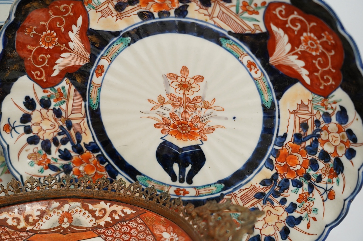 Five Japanese Imari dishes and a Kutani gilt metal mounted bowl, Meiji period, largest 35cm. Condition - poor to fair